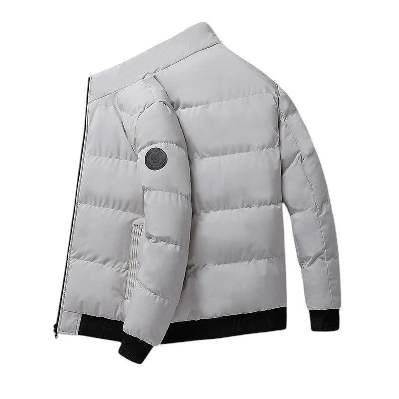COMFORTH Men's light grey quilted puffer jacket with stand collar, black ribbed cuffs and hem.