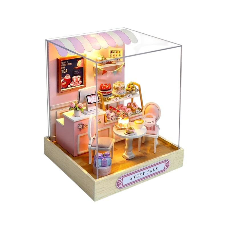 COMFORTH miniature bakery dollhouse building kit with cakes, pastries, chairs, and display shelves.