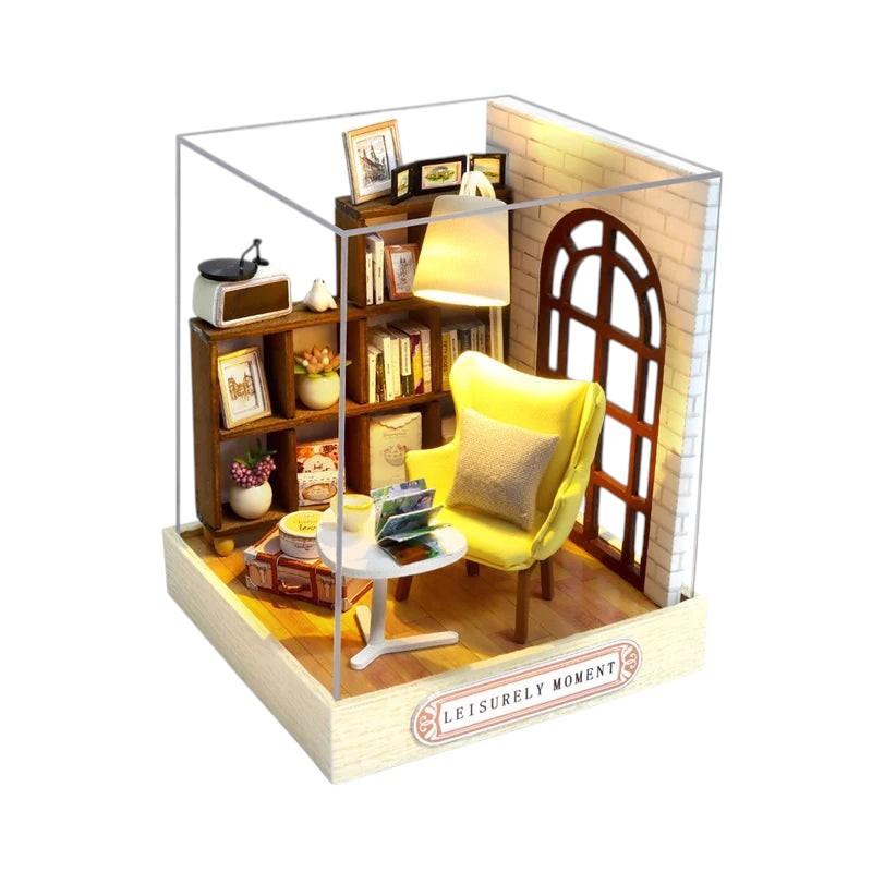COMFORTH Miniature dollhouse building kit featuring a cozy living room scene with a yellow armchair, bookshelf, and table.