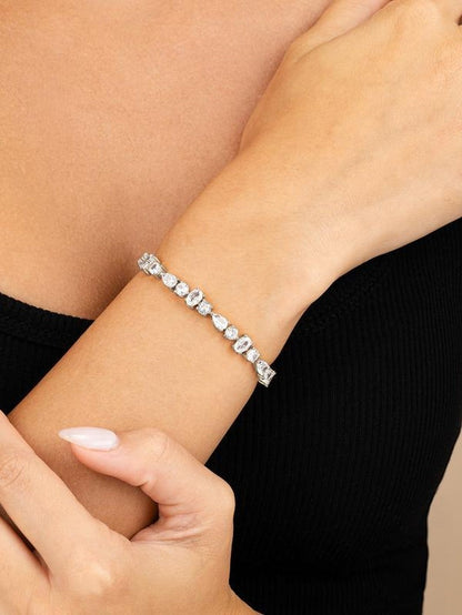 COMFORTH mixed shape tennis bracelet with round, oval, and pear cut crystal accents on a gold-tone finish.