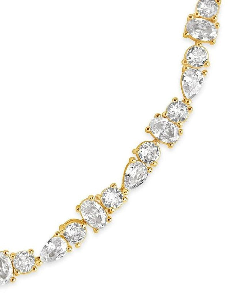 COMFORTH Mixed shape tennis bracelet with clear crystal accents on a gold-tone finish. Features round, oval, and pear cuts.