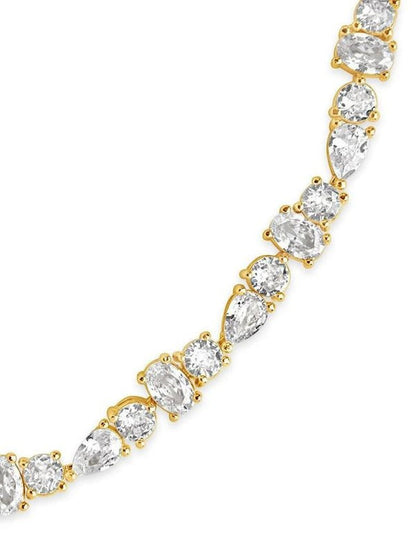 COMFORTH Mixed shape tennis bracelet with clear crystal accents on a gold-tone finish. Features round, oval, and pear cuts.
