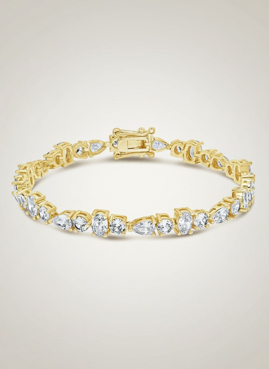 COMFORTH Mixed shape tennis bracelet with crystal accents in round, oval, and pear cuts, gold-tone finish.