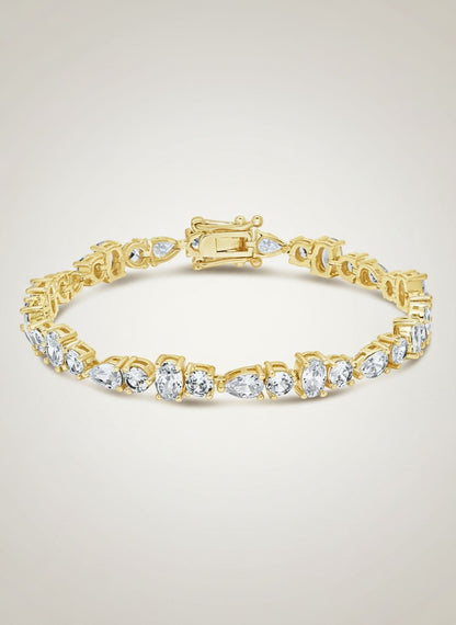 COMFORTH Mixed shape tennis bracelet with crystal accents in round, oval, and pear cuts, gold-tone finish.