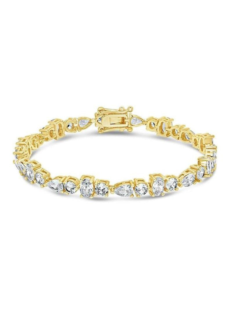COMFORTH Mixed shape tennis bracelet with clear crystal accents in round, oval, and pear cuts on a gold-tone finish.