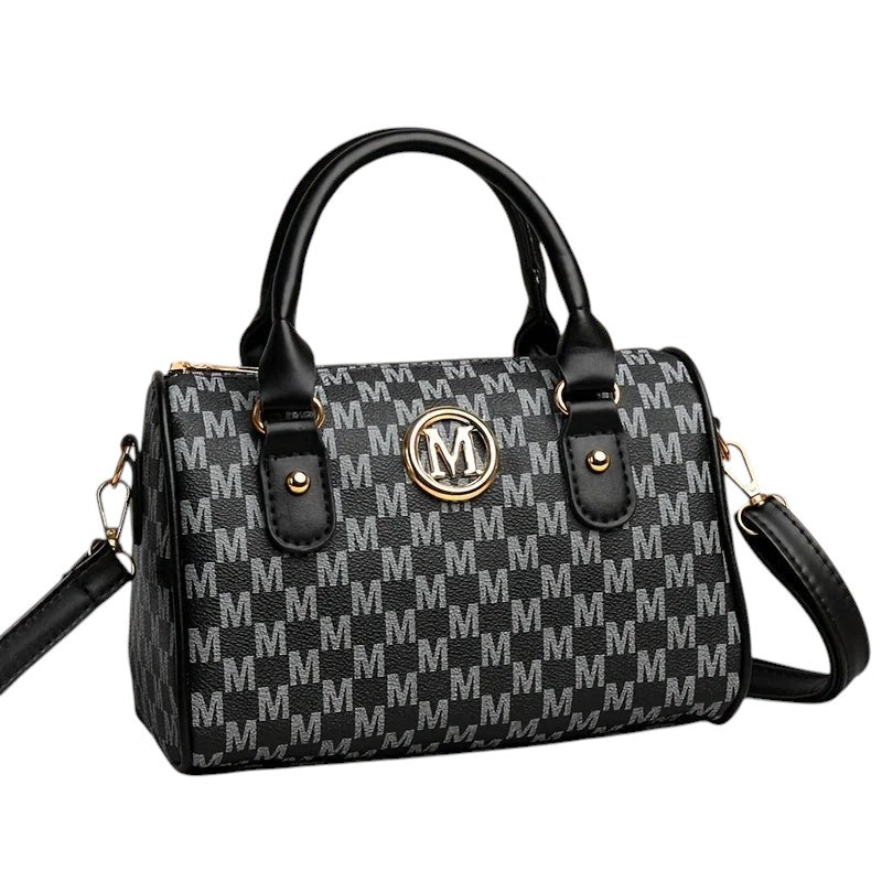 COMFORTH Monogram Barrel Handbag with shoulder strap, black and grey monogram print, gold M emblem, top handles, and detachable strap.