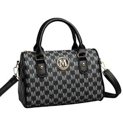 COMFORTH Monogram Barrel Handbag with shoulder strap, black and grey monogram print, gold M emblem, top handles, and detachable strap.