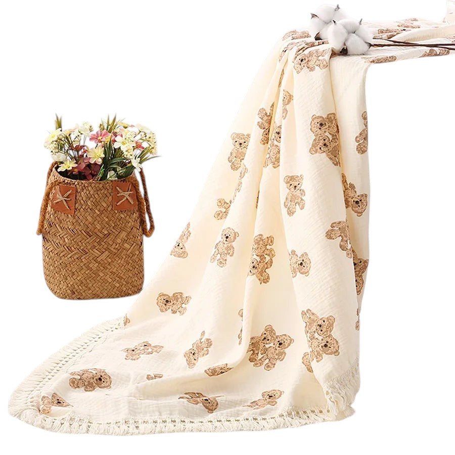COMFORTH Muslin blanket with all-over teddy bear print and fringe detail. Cream with brown bears.