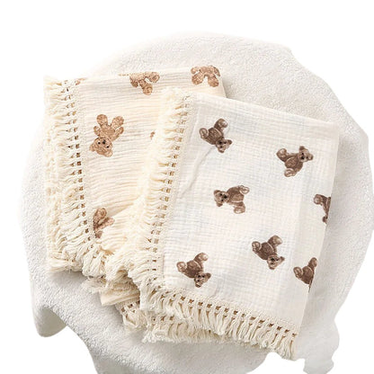 COMFORTH muslin blanket with fringe and all-over teddy bear print in neutral tones.