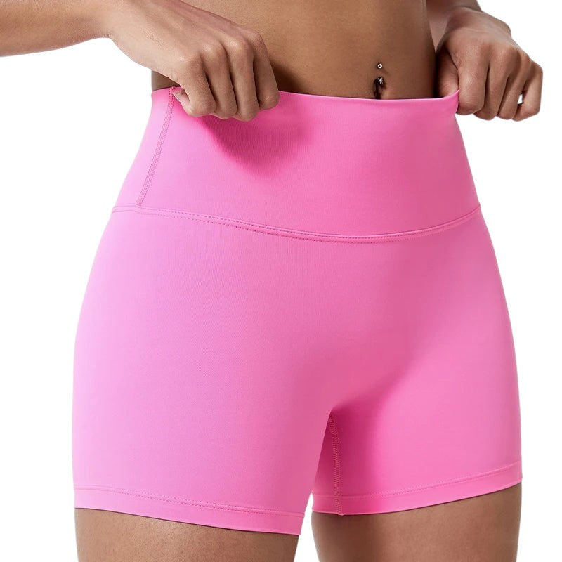 COMFORTHere's a close-up of bright pink athletic shorts for women. The shorts have a high waist and are made of a stretchy, breathable fabric.