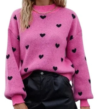 COMFORT pink knit sweater with black heart pattern, crew neck, long sleeves, and ribbed cuffs and hem.