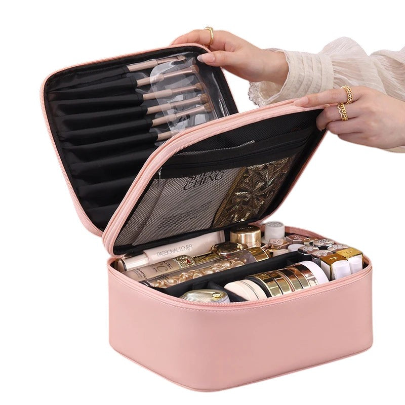 COMFORT pink PU leather travel makeup bag organizer with brush holder and interior compartments filled with cosmetics.