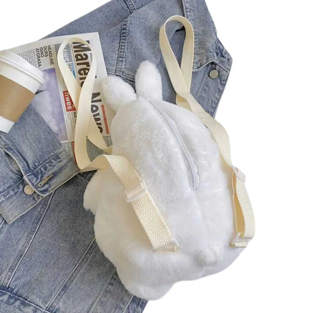 COMFORTH white plush bunny backpack with cream straps and zipper, featuring long ears and a soft, fuzzy texture.