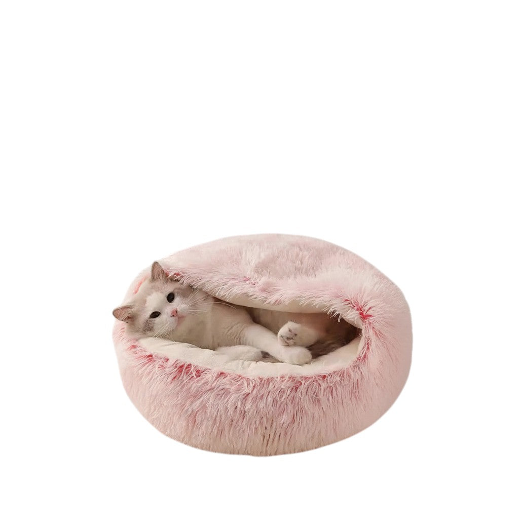 COMFORT plush pink enclosed cat bed with a white cat burrowed inside, offering a cozy and secure napping spot.