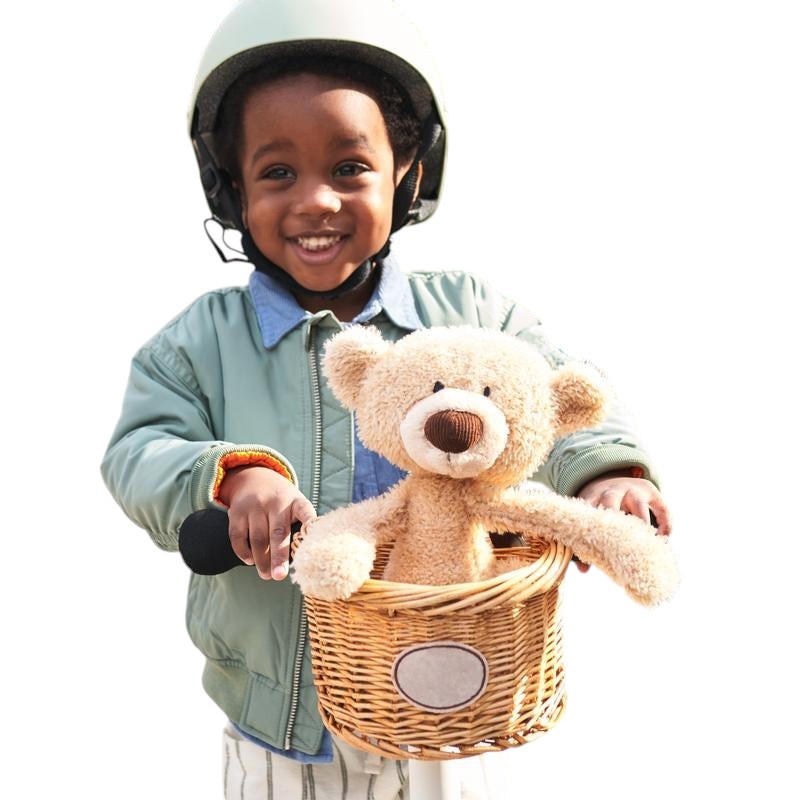 COMFORT plush teddy bear toy in beige with brown nose, held by a child wearing a helmet and jacket.