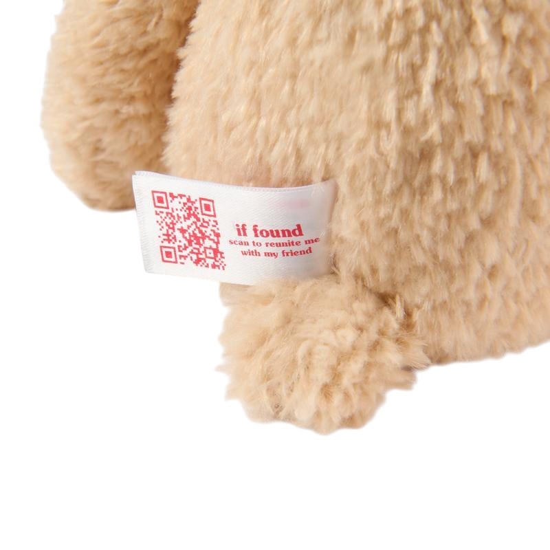 COMFORT plush teddy bear toy in beige with "if found scan to reunite me with my friend" tag and QR code.