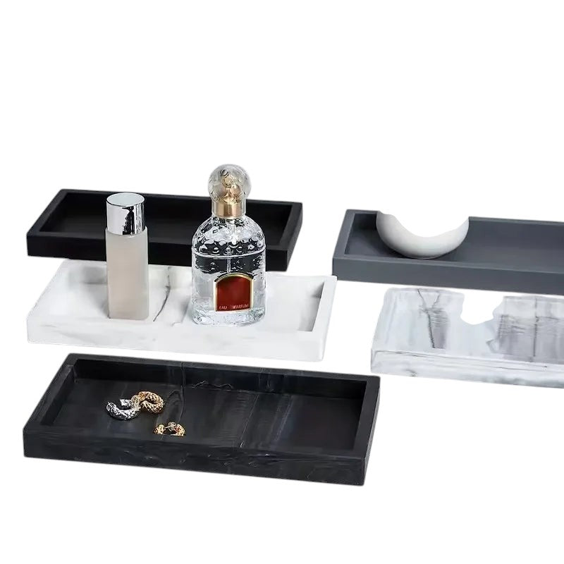 COMFORTH Rectangular decorative tray in white marble finish with perfume bottles and jewelry. Also shown are black and grey trays.