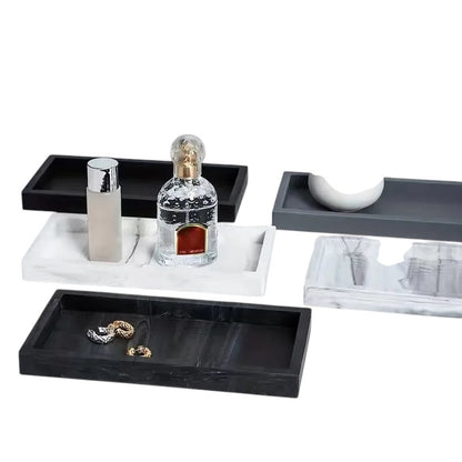 COMFORTH Rectangular decorative tray in white marble finish with perfume bottles and jewelry. Also shown are black and grey trays.