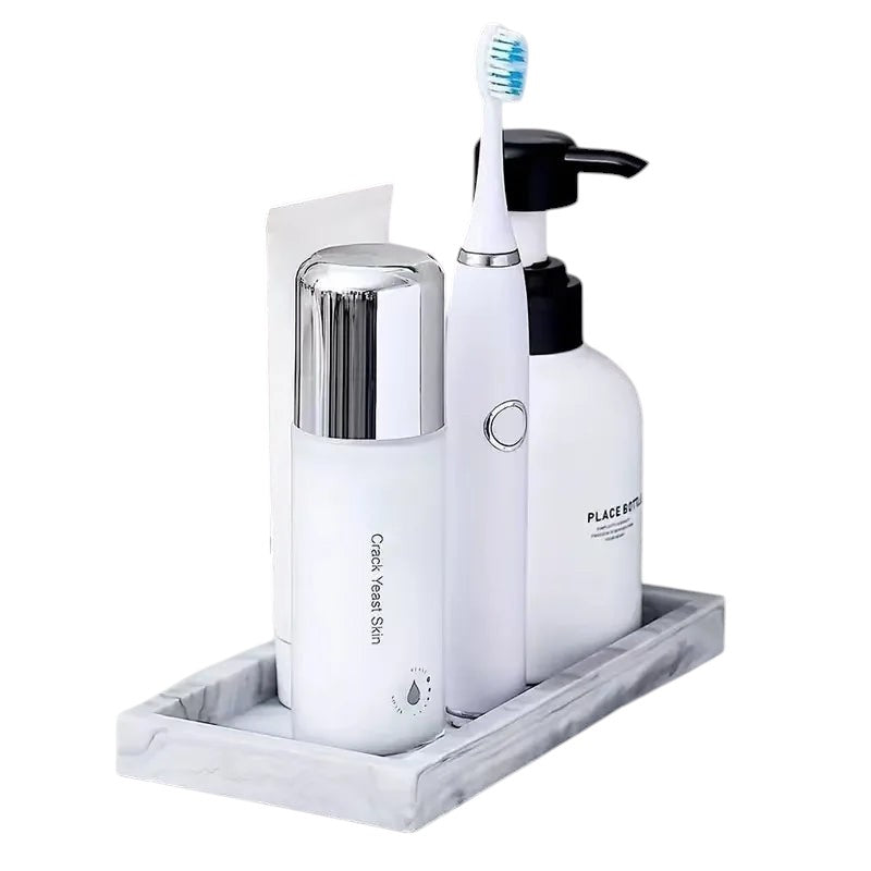 COMFORTH white marble resin decorative tray holding a white electric toothbrush, soap dispenser, and skincare bottle.