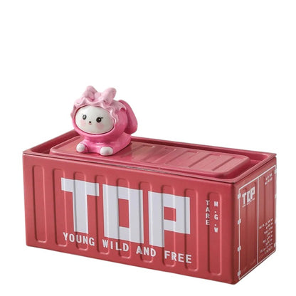 COMFORTH red metal storage container shaped like a shipping container with a cute pink bunny figurine on top. Features "TOP YOUNG WILD AND FREE" text.