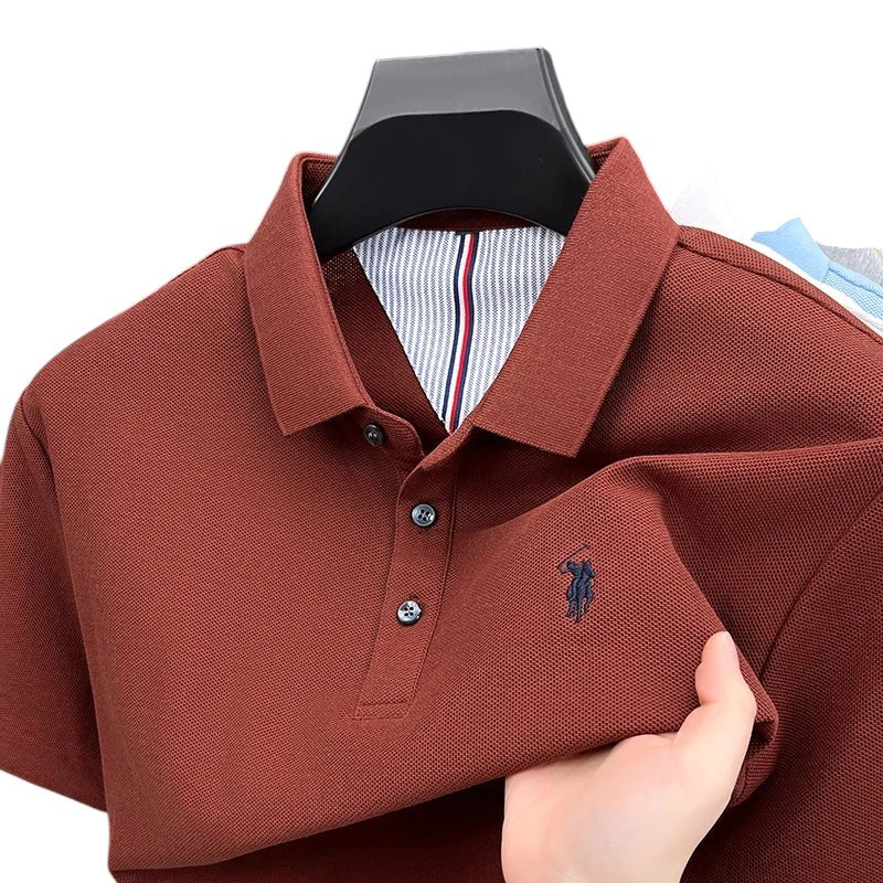COMFORTH men's short sleeve polo shirt in rust red pique knit with embroidered logo and striped inner collar detail.