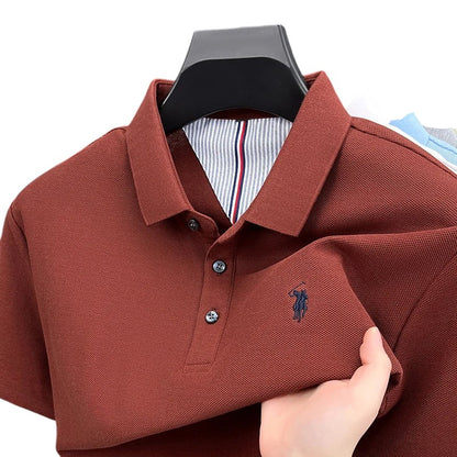 COMFORTH men's short sleeve polo shirt in rust red pique knit with embroidered logo and striped inner collar detail.