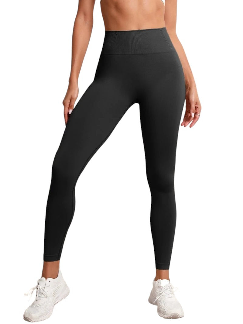 COMFORTHigh waisted seamless black workout leggings with textured detail and white sneakers