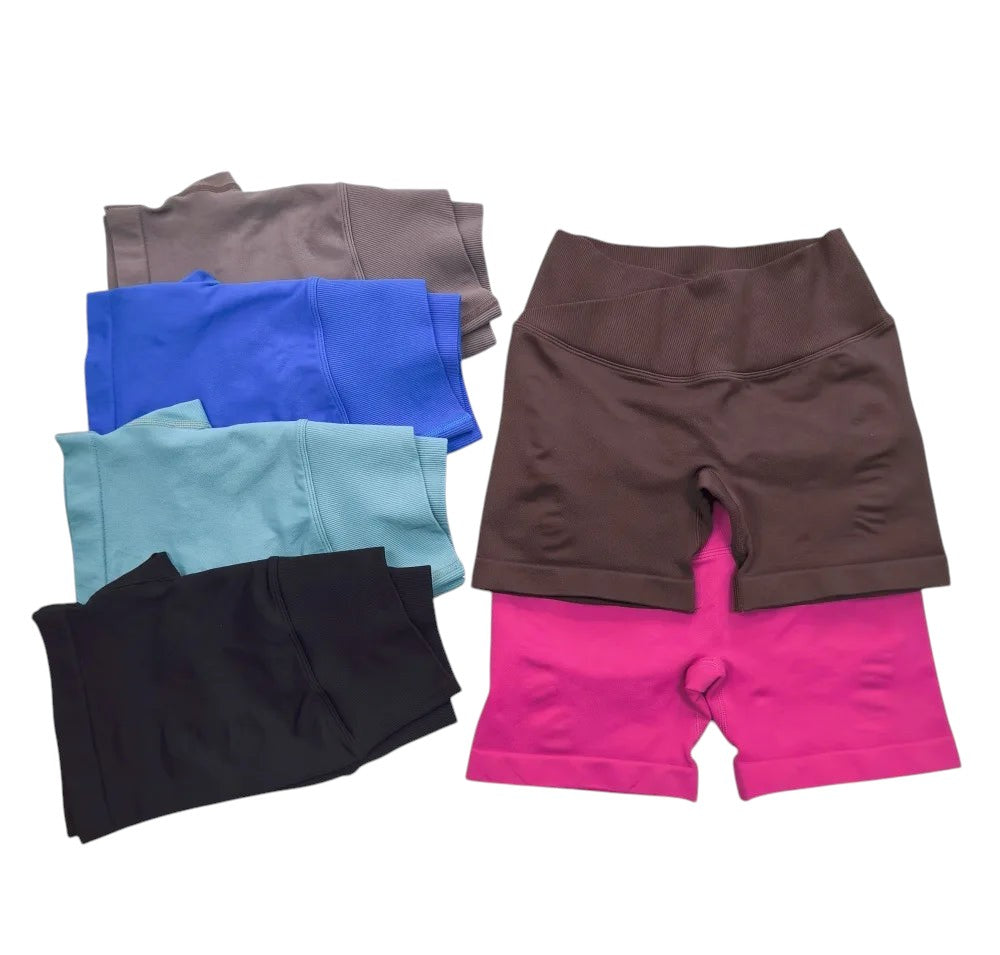 COMFORTH seamless V-waist athletic shorts in brown, pink, grey, blue, teal, and black. Soft, breathable, stretchy fabric.