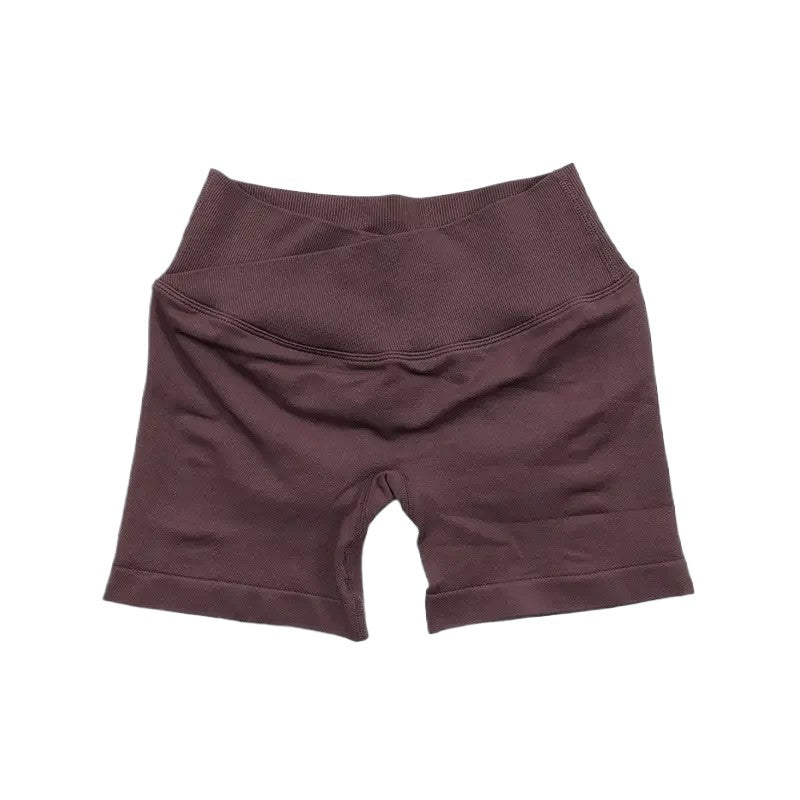 COMFORTH seamless V-waist athletic shorts in mauve, made from a stretchy, breathable fabric. Designed for workouts.