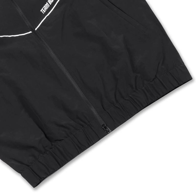 COMFORTH black track jacket with white piping and TEAM BLACK MMA graphics on back. Full zip, stand collar.