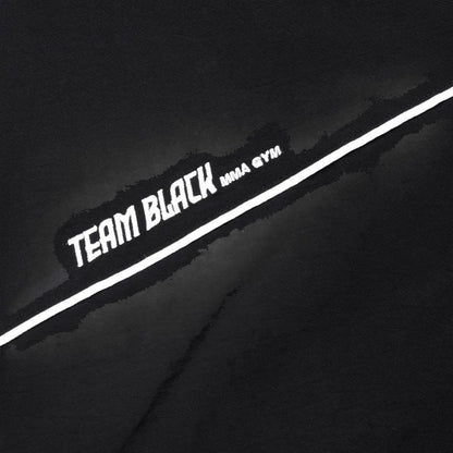 COMFORTH black track jacket with white piping and "TEAM BLACK MMA GYM" graphic. Lightweight material, full-zip, stand-up collar.
