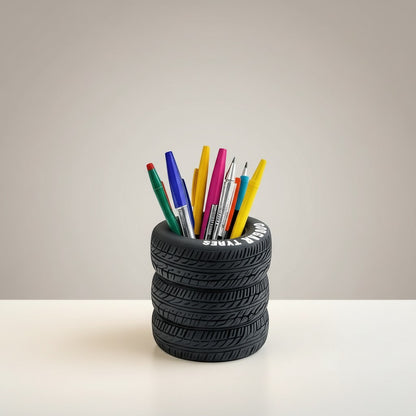 COMFORT tire-shaped desk organizer pen holder with realistic tread and embossed branding, holding colorful pens and pencils.