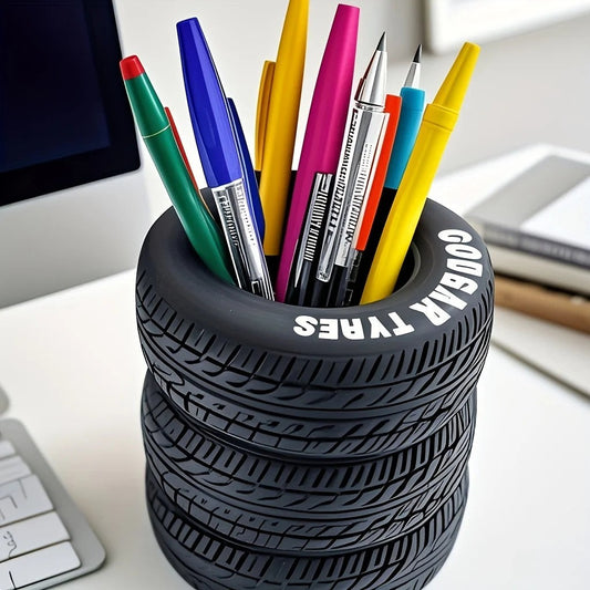 COMFORT tire-shaped desk organizer pen holder with realistic tread pattern and "GOODYEAR TYRES" text, holding colorful pens.
