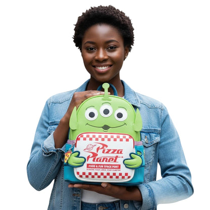 COMFORTH Toy Story Pizza Planet alien backpack with Woody details, green vegan leather, and checkered front pocket.