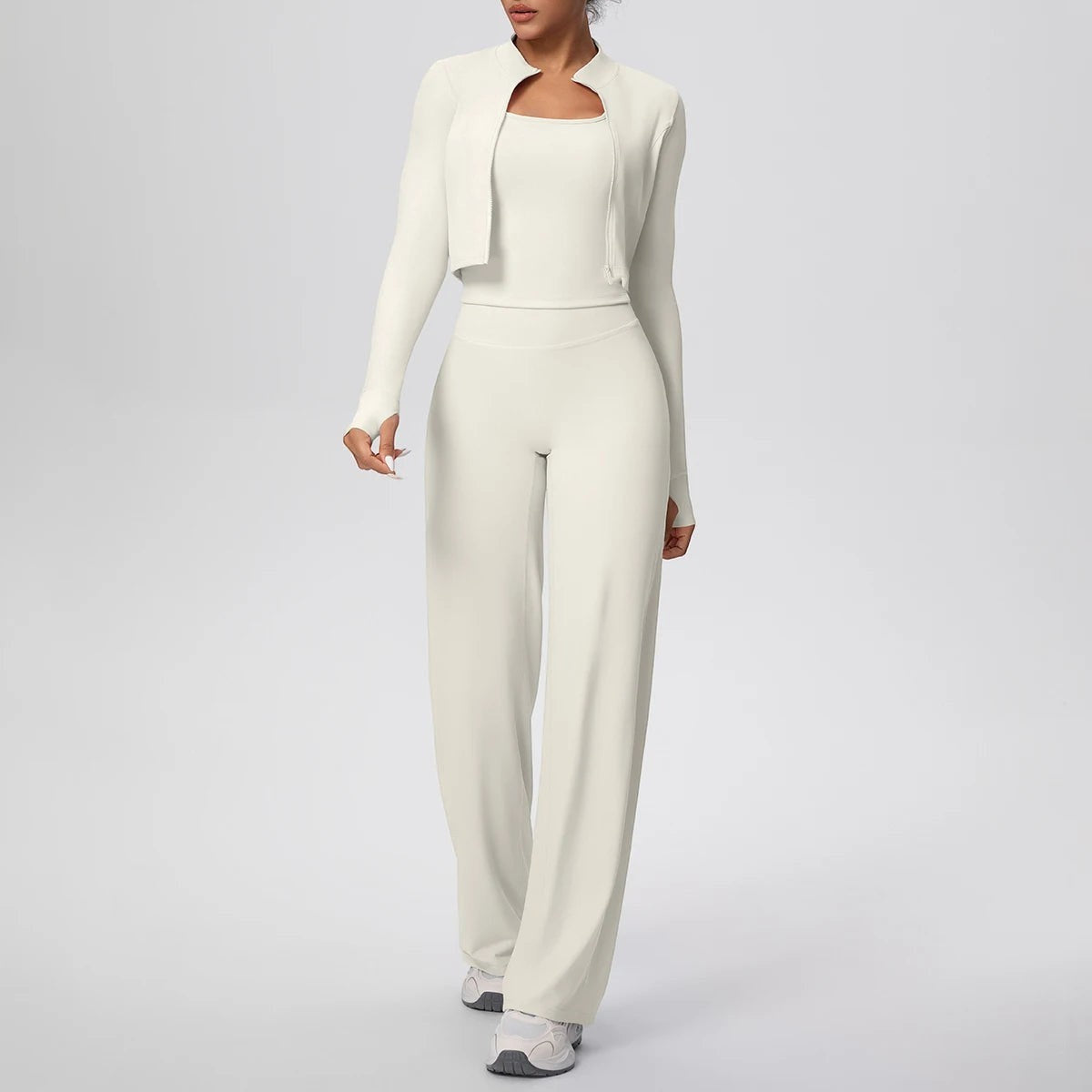 COMFORT Women's cream three-piece athletic set with cropped jacket, scoop-neck bra, and wide-leg pants.