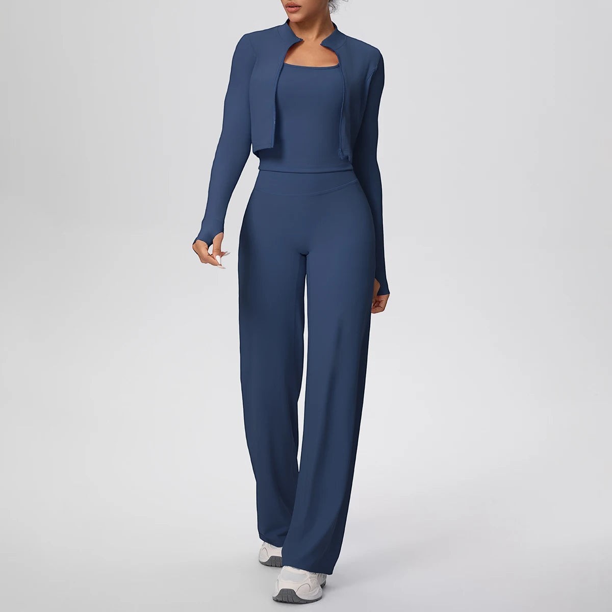 COMFORT Women's navy blue three-piece athletic set with cropped jacket, sports bra, and wide-leg pants.