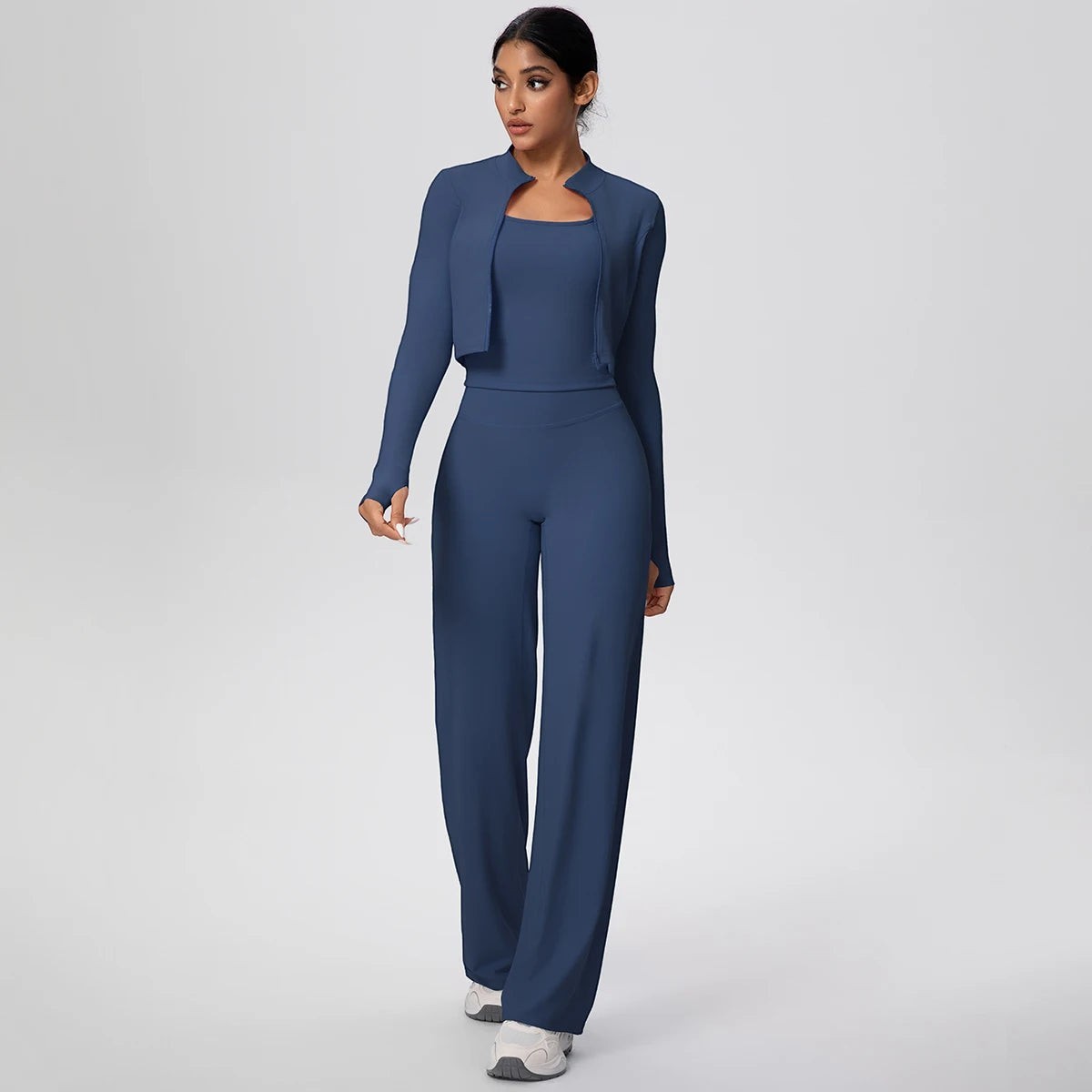 COMFORT Women's navy blue three-piece athletic set with cropped jacket, sports bra, and wide-leg pants.