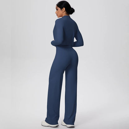 COMFORT Women's navy blue three-piece athletic set with cropped jacket and wide-leg pants on a model.