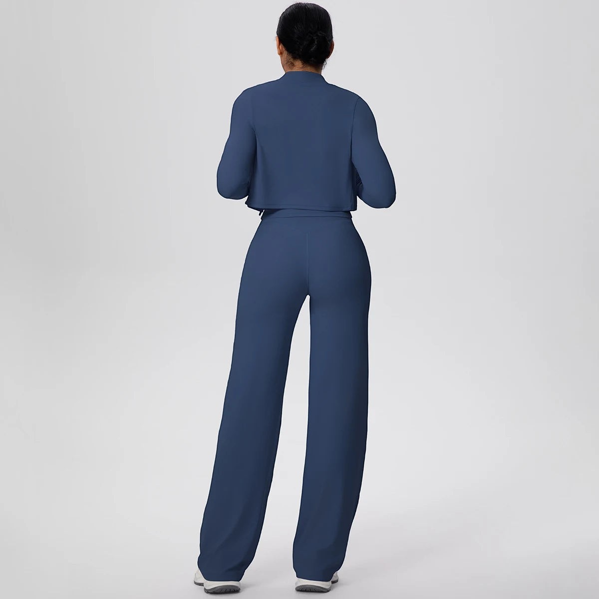 COMFORT Women's navy blue three-piece athletic set with cropped jacket and wide-leg pants.