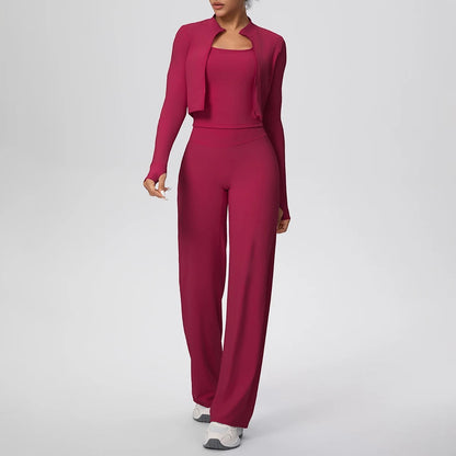 COMFORT Women's three-piece athletic set in deep pink, featuring a cropped jacket, sports bra, and wide-leg pants with thumbholes.