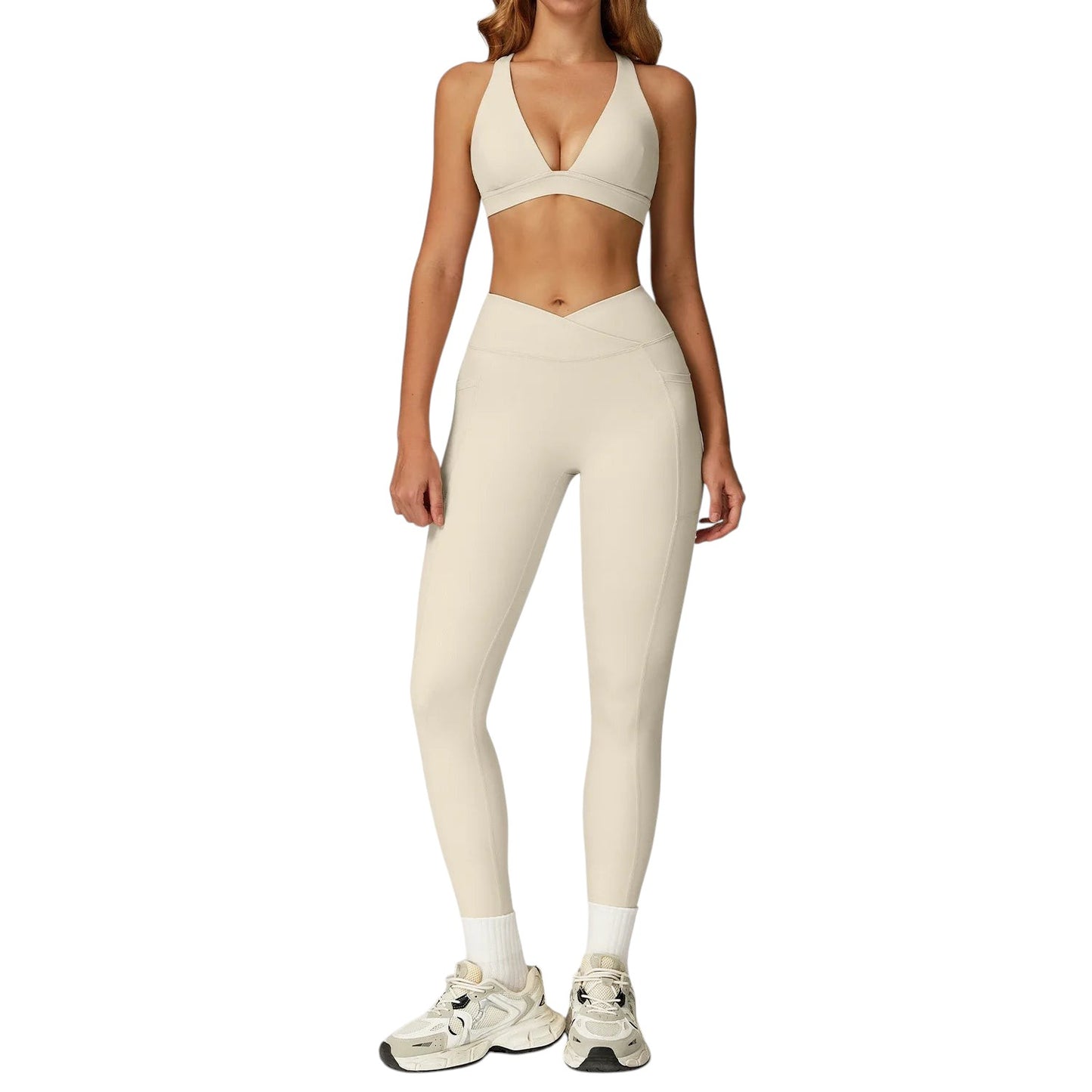 COMFORTH women's beige athletic two-piece set with V-neck sports bra and high-waisted flare leggings with V-waistband.