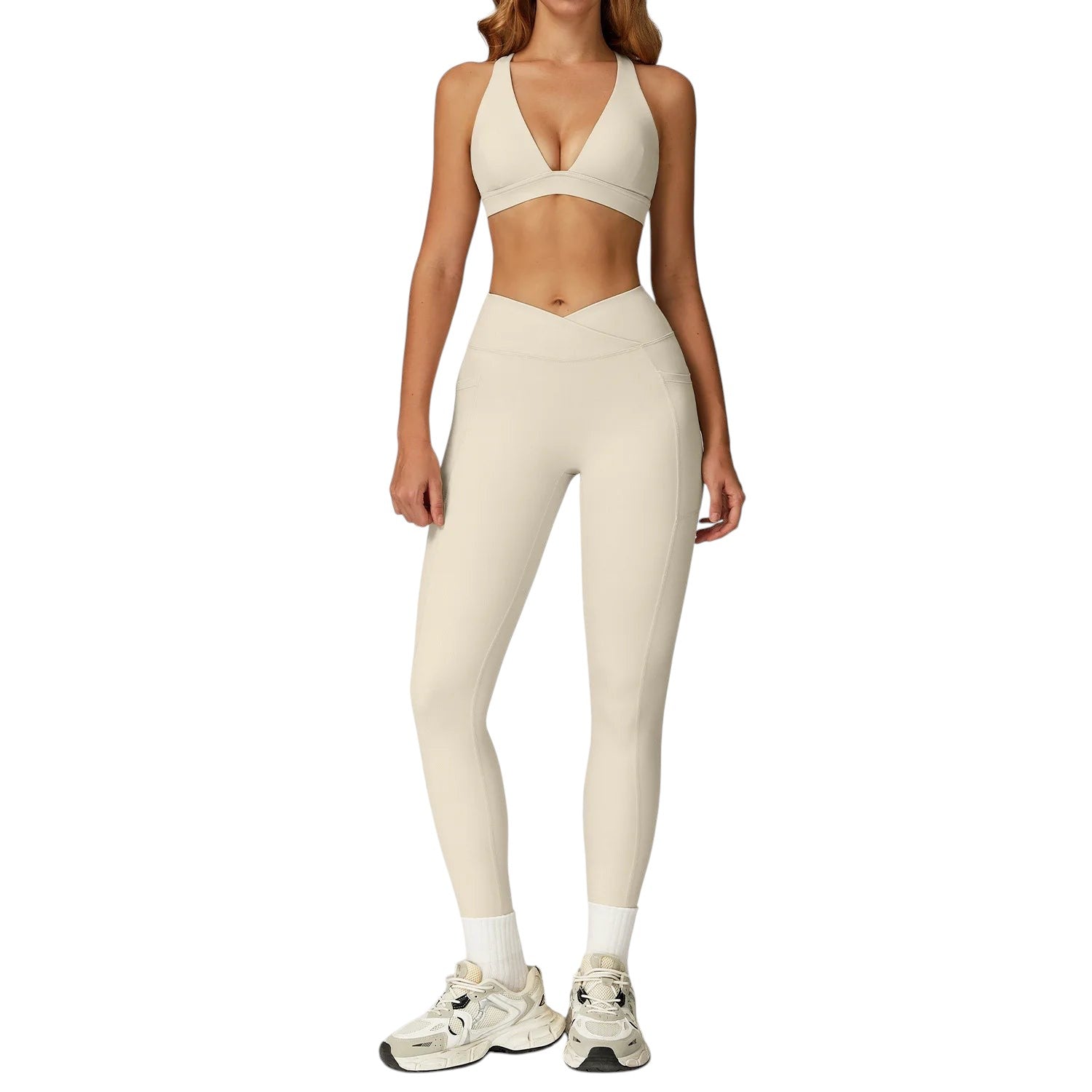 COMFORTH women's beige athletic two-piece set with V-neck sports bra and high-waisted flare leggings with V-waistband.