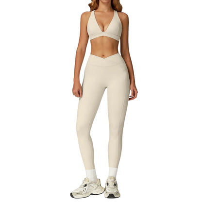COMFORTH women's beige athletic two-piece set with V-neck sports bra and high-waisted flare leggings with V-waistband.