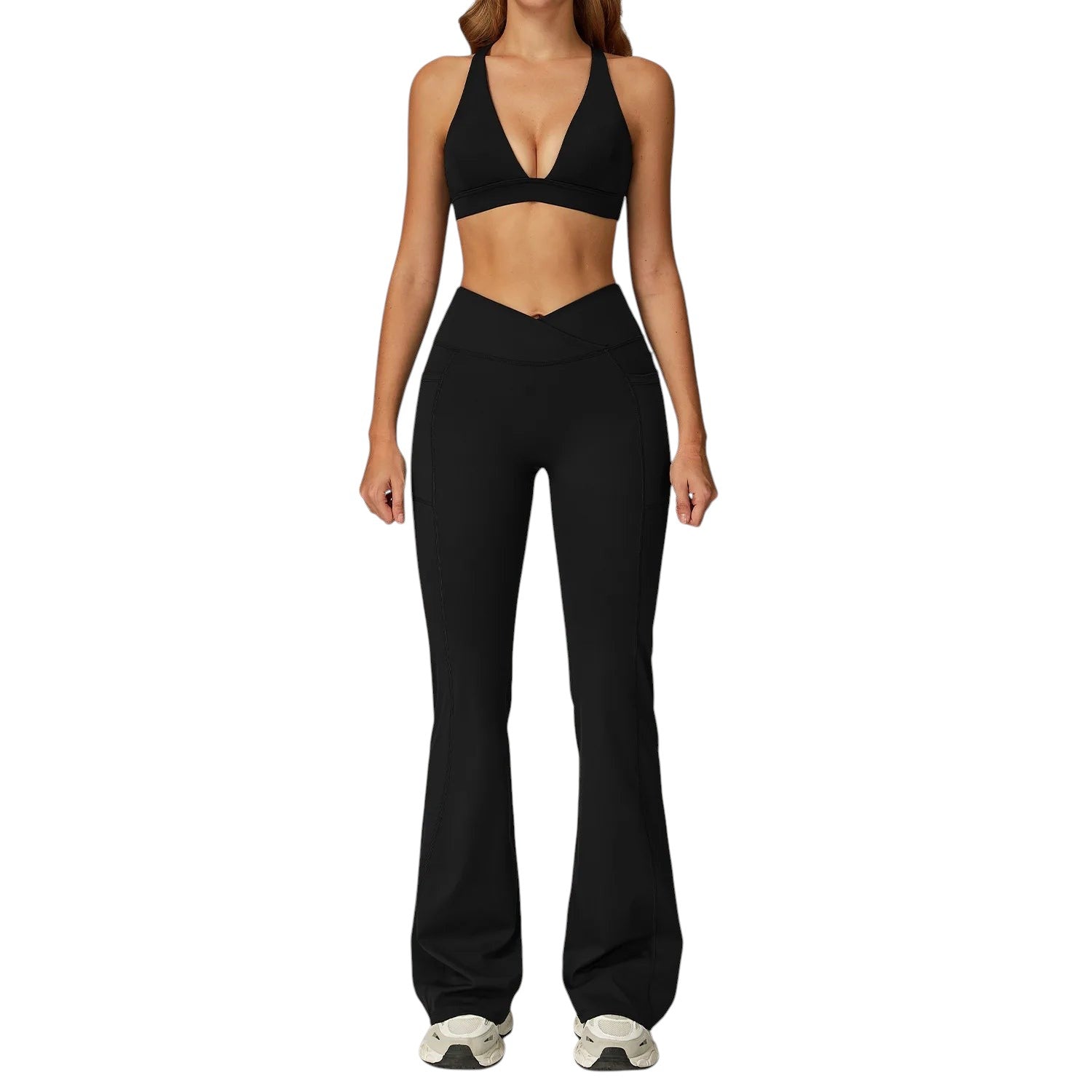 COMFORTH Women's black athletic two-piece set with halter neck sports bra and V-waist flare leggings. Stretchy fabric.