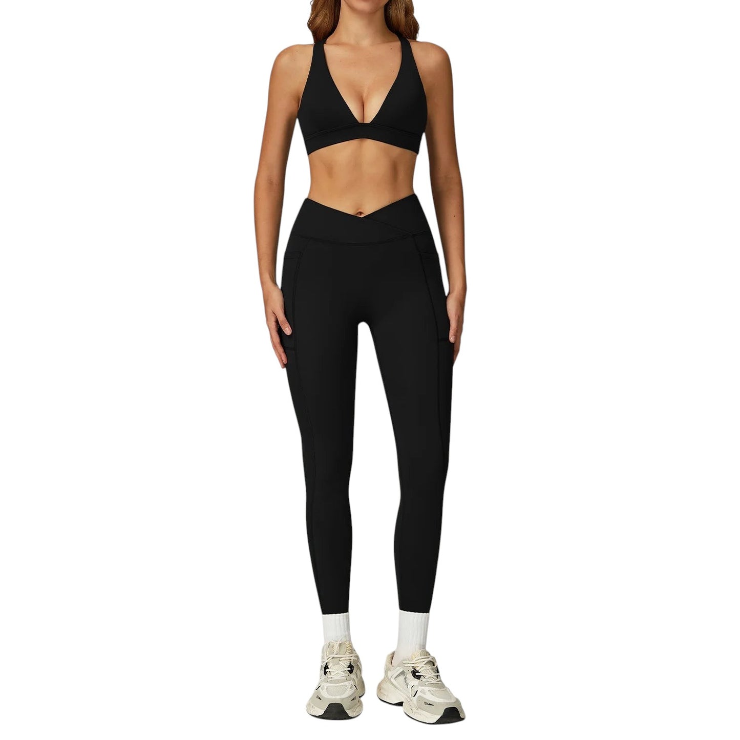COMFORTH Women's black athletic two-piece set with V-neck sports bra and high-waisted flare leggings with V-waistband and pockets.