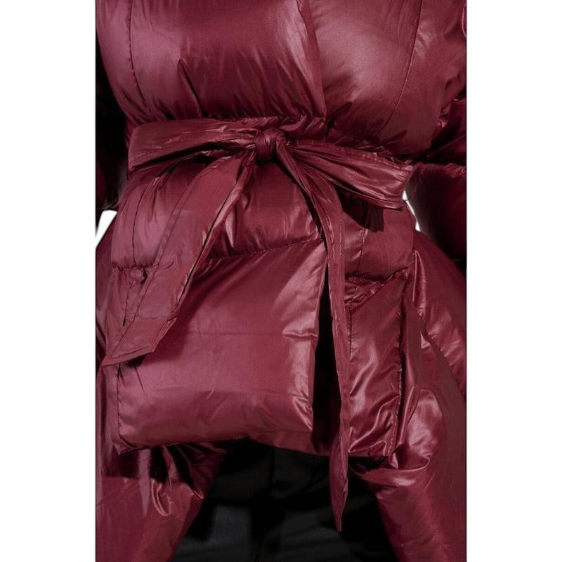 COMFORT Women's deep burgundy puffer jacket with wrap silhouette and tie belt. Lustrous material, voluminous sleeves.
