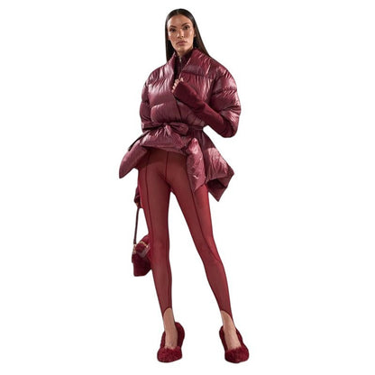 COMFORT Women's burgundy puffer jacket with tie-waist belt, voluminous sleeves, and high collar.