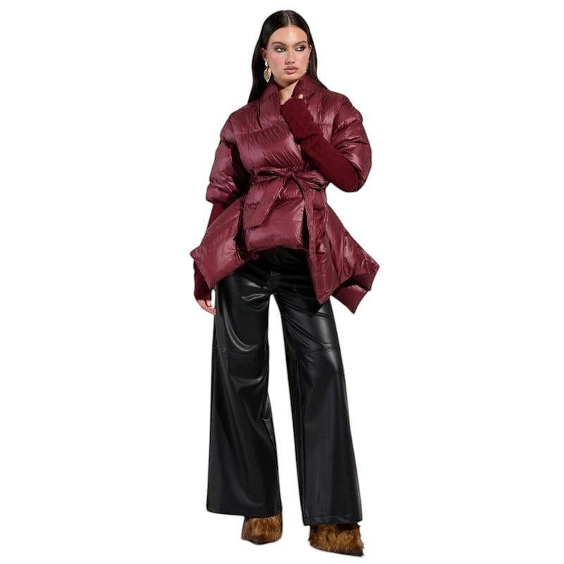 COMFORT Women's burgundy puffer jacket with belt, voluminous sleeves, and wrap silhouette.