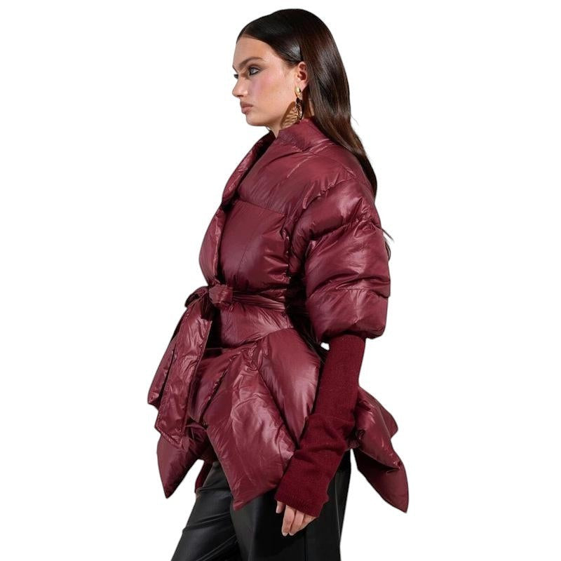 COMFORT Women's burgundy puffer jacket with belt, voluminous sleeves, and wrap silhouette.