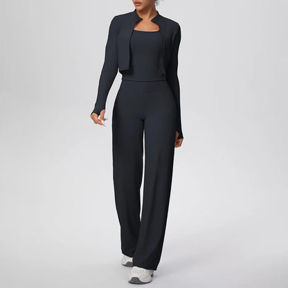 COMFORT Women's black three-piece athletic set with cropped jacket, sports bra, and wide-leg pants.
